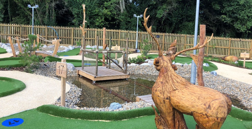 The woodland themed adventure golf at China Fleet with wooden animal sculptures 
